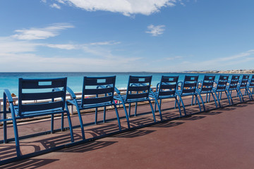 row of blue chairs on quay in Nice, France