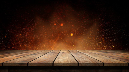 Wood table with flame effect on dark background. 