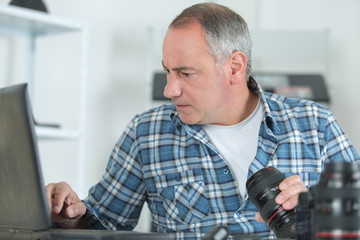 technician repairing digital camera in a service laboratory