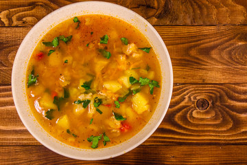 Georgian traditional food soup kharcho on wooden table. Top view