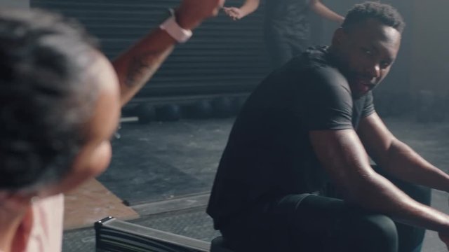 happy woman athlete resting after intense exercise diverse friends high five enjoying fitness workout together in gym