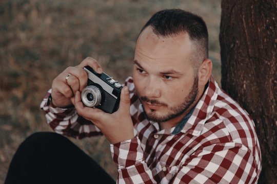 Portrait of a handsome bearded young man, taking pictures