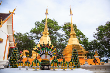 Naklejka premium Wat Phra That Doi Tung temple with public domain has two golden pagodas or stupas containing Buddha's relic, considered as a treasure of Buddhism, Mae Sai, Chiang Rai, Thailand. Thai Travel Tourism.
