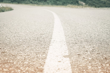 Asphalt road with white solid line.