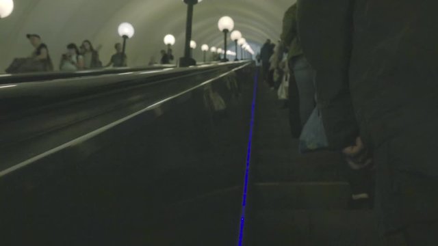 People climb the escalator. Metro.