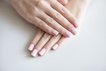 Manicured hands on towel. French manicure.
