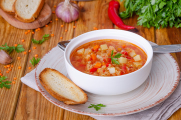 Spicy soup with red lentils, tomatoes, leek, bell pepper, carrots and potatoes.