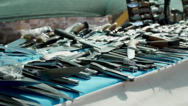 Much knives and blades on the merchant table Cold weapon