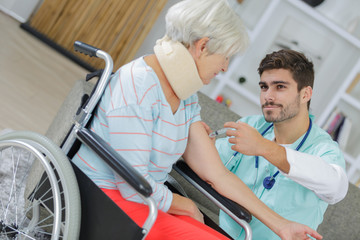 carer supporting old woman with health afflictions