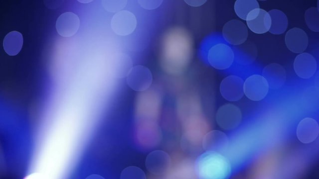 The athlete enters the ring, raising his hands up. Blurring