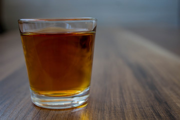 a pile of whiskey on a wooden background