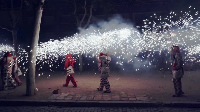 Traditional correfoc performance. In the correfoc, a group of individuals will dress as devils or Diables and light fireworks - fixed on devil's pitchforks or strung above the route