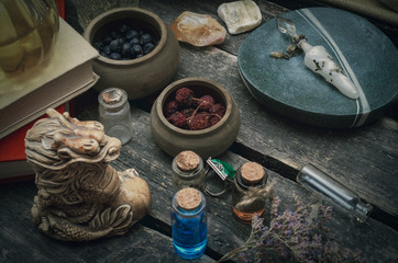 Magic potion preparation on the table of magician. Witchcraft or druidism concept background.