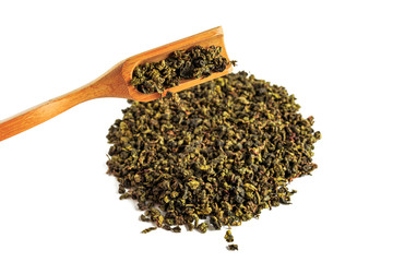 Chinese green teguanin tea, scattered on a white background, poured with a tea spatula and a tea filter.