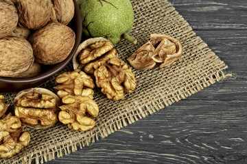 Walnuts on rustic table in clay bowl. Walnut kernels. Walnut healthy food.