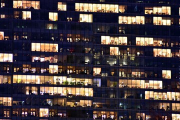 Office building at night. Late night at work. Glass curtain wall office building