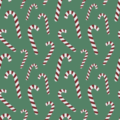 Seamless pattern for Christmas and New Year. Hand-drawn vector illustration of candy canes on a green background.