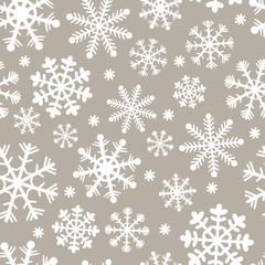 Seamless pattern for Christmas and New Year. Hand-drawn vector illustration of snowflakes in white on a beige background.
