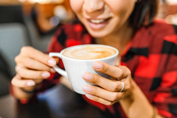 Female hipster with coffee cup closeup