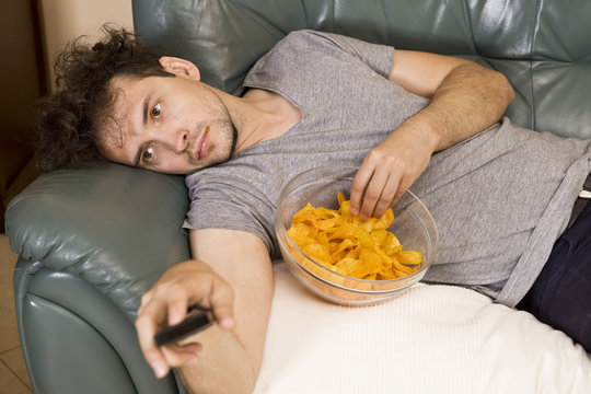Man's relax after work, beer and chips. Lazy man