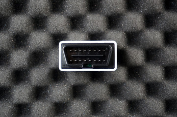 Small OBD2 interface on black foam
