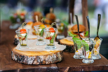 Canape on a round birch log. Small depth of field.