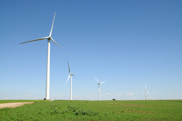 Utility windmills generating electricity on a sunny cloudless day