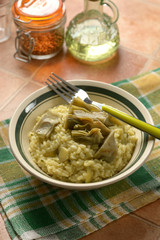 risotto with artichokes in the bowl - closeup