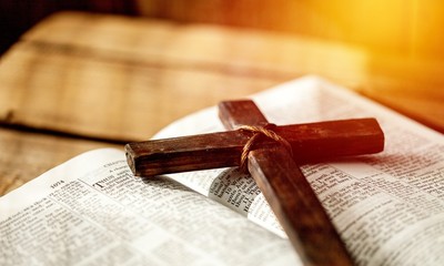 Holy Bible book and cross, close-up view - obrazy, fototapety, plakaty