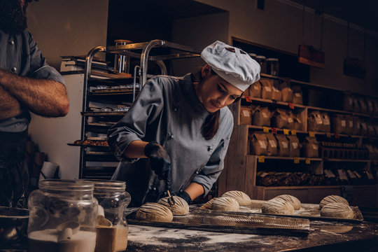 Cooking Master Class In Bakery. Chef With His Assistant Showing Ready Samples Of Baking Test In Kitchen.