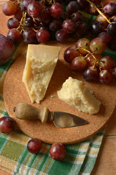 parmesan cheese on the table with bunch of grapes