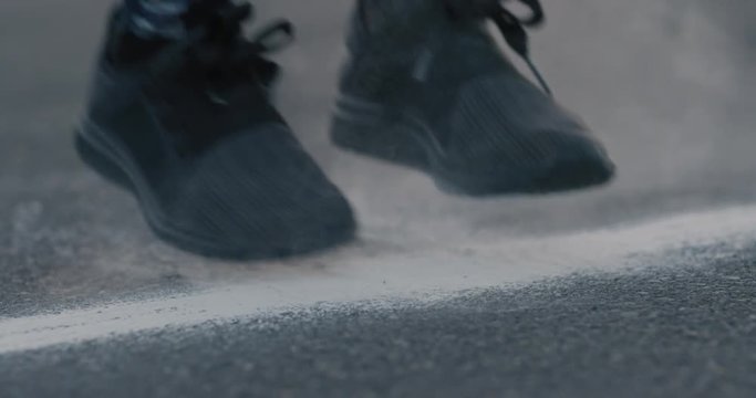 woman runner feet athlete warm up preparing  fitness workout stepping on chalk powder in city at sunrise slow motion