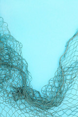 Fishing net with space for your text. Blue background for a fishery theme.