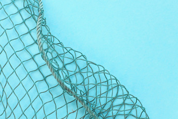 Fishing net with space for your text. Blue background for a fishery theme.