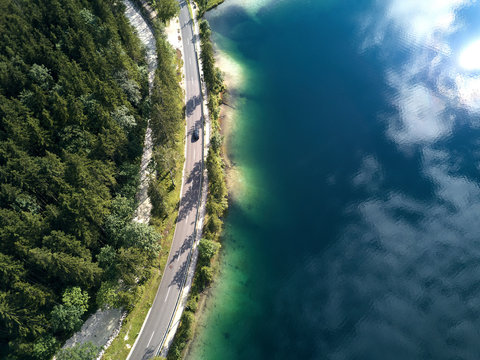 Aerial view of the road near the lake and the forest from above © visualitte