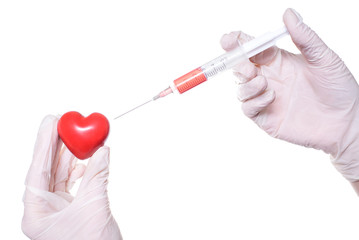 Close up photo of doctor's hands giving injection into the red small heart