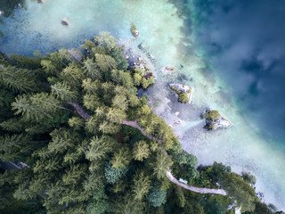 Aerial view of the road near the lake and the forest from above © undWITTE