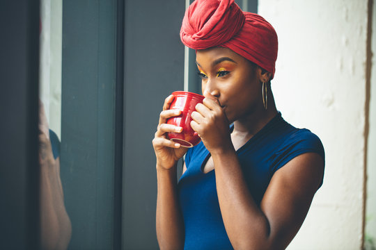 Portrait of woman in turban holding mug