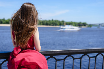 Fototapeta premium Sky cloud adventure city getawaylove enjoy lonely alone single happiness concept. Rear back behind view photo portrait of pretty lady in red dress with long hair looking at ocean. Leisure lifestyle