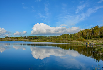 Fototapeta na wymiar Sunny autumn day on the shore of an artificial lake.