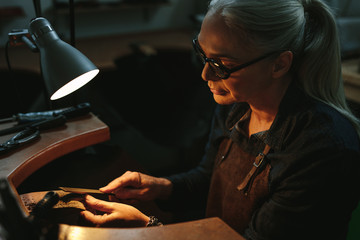 Goldsmith shaping an unfinished jewelry piece
