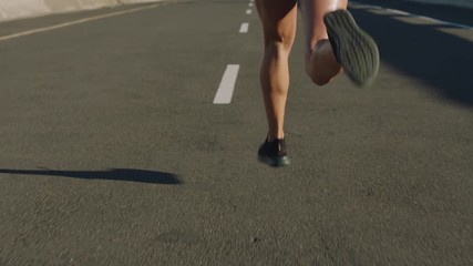 attractive young woman athlete running in city jogging exercising healthy fitness lifestyle female runner on sunny urban road slow motion