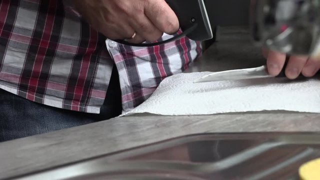 The man is sharpening a kitchen knife