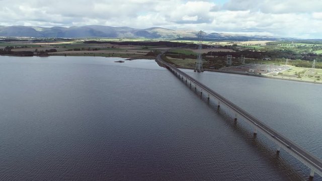 Aerial footage of traffic crossing Clackmannanshire Bridge over the River Forth.