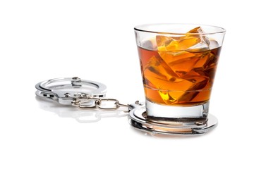 glass of liqour with handcuffs