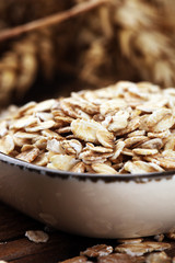 Oatmeal and oatmeal on the wooden background. Healthy eating concept