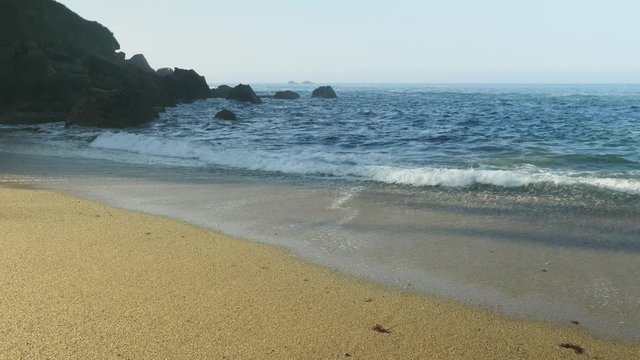 Blue Atlantic Ocean waves at the wild rocky beach