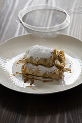 caramel banana crepe on white plate