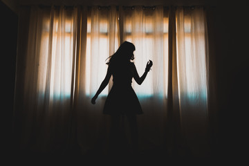 silhouette of a girl dancing in window