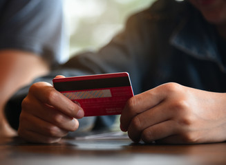 Online payment,woman's hands holding credit card and using tablet for online shopping. Cyber Monday Concept